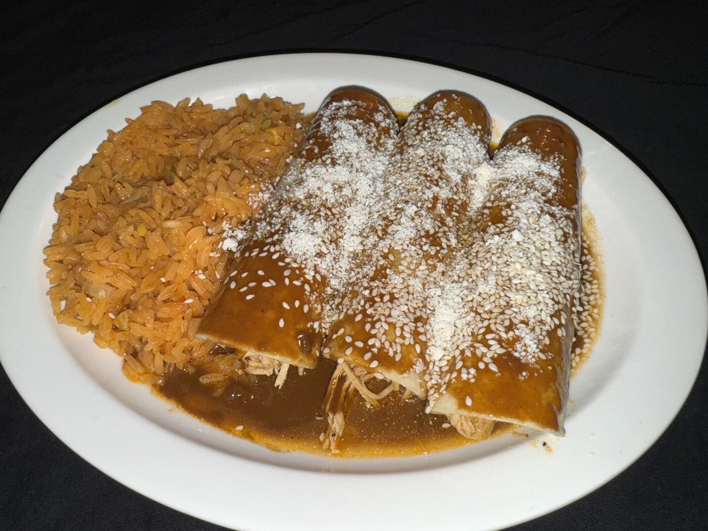 Enchiladas Poblanas topped with mole